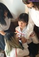 A group of young women in school uniforms are tied up.